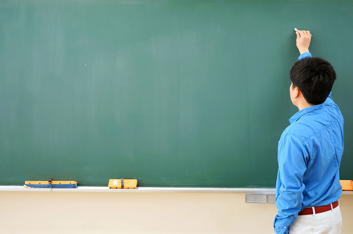 Man teaching on a chalk board